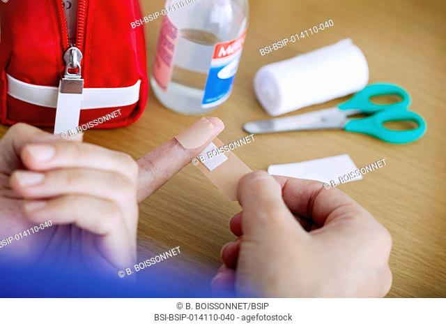 Woman putting a band-aid