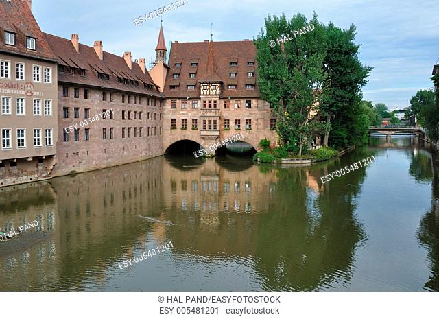 weinhhaus spital, nurnberg, view of city center with ancient building of hospital reflected in river water