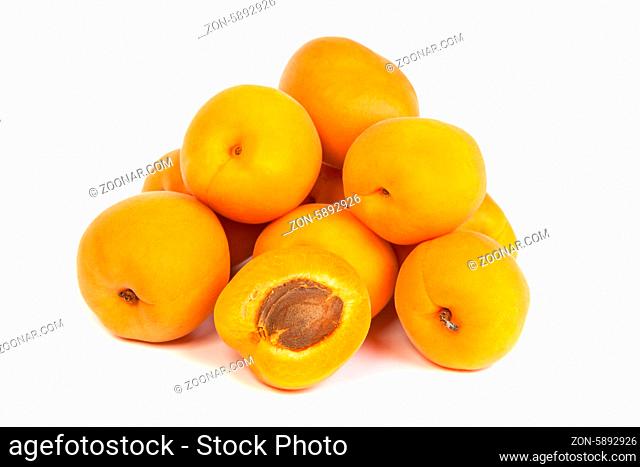 Group of ripe apricots with a half isolated on a white background