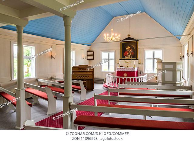 Nordurland Eystra, Iceland - July 2, 2016: interior of the church with red benches and white wooden interior in Iceland