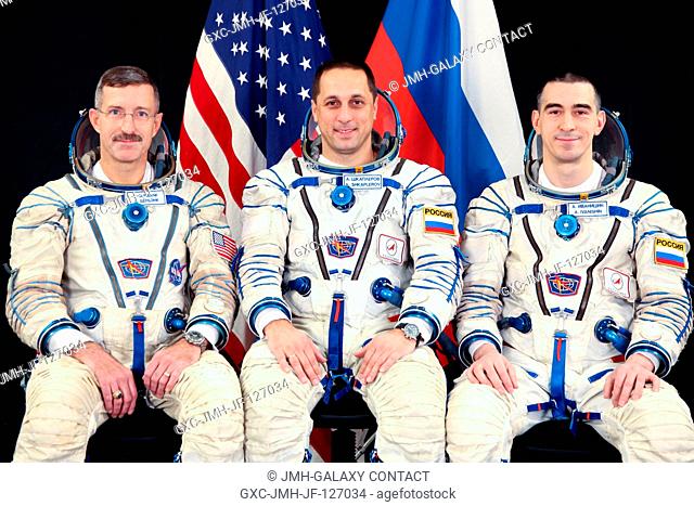 Attired in Russian Sokol launch and entry suits, NASA astronaut Dan Burbank (left), Russian cosmonauts Anton Shkaplerov (center) and Anatoly Ivanishin