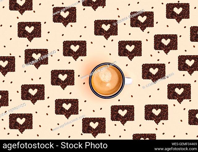 Pattern of mug of coffee surrounded by roasted coffee beans arranged into shapes of online chat bubbles