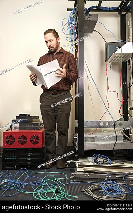 An IT employee looks confused while putting together a server