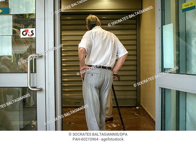 An elderly man waits outside a bank in Athens, Greece, 20 July 2015. Greek banks reopened on July 20 after a shutdown lasting three weeks but many restrictions...