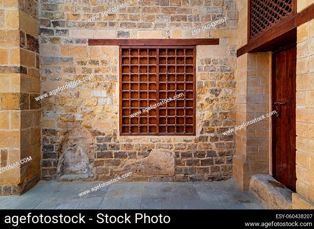 Mamluk era wooden closed window with wooden ornate grid over stone bricks wall, Tekkeyet Al Bustami, Dar El Labana district, Cairo, Egypt