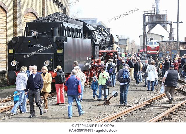 Visitors walk past a historical locomotive at the rail yard Schöneweide in Berlin, Germany, 20 April 2013. More than 40 historical locomotives and cars are...