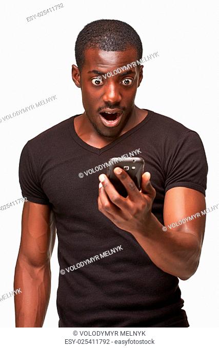 Portrait of surprised african man talking on the phone isolated on a white background