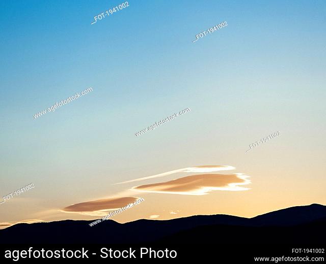 Ethereal cloud formations in clear sunset sky