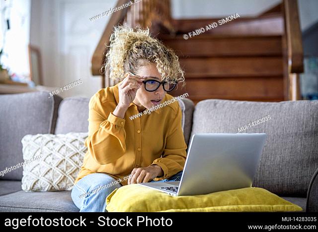 Woman, Blonde, Curls, Sofa, Sitting, Mobile phone, laptop
