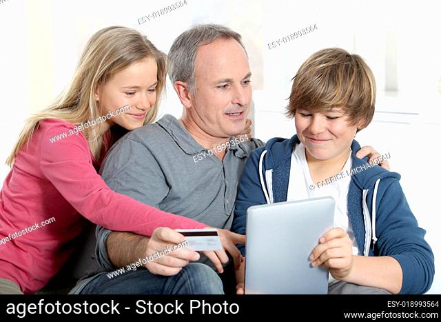 Father and children doing online shopping at home