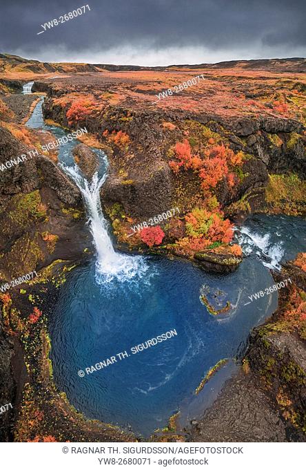 From above lava and moss landscape in the autumn, Gjaarfoss in the Thjorsardalur valley, Iceland. This image is shot with a drone