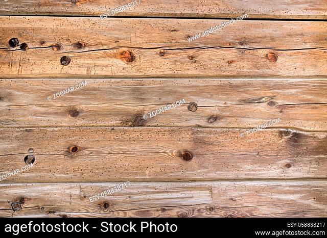 Natural brown barn wood wall. Wall texture background pattern. Wood planks, boards are old with a beautiful rustic look, style and woodworm holes