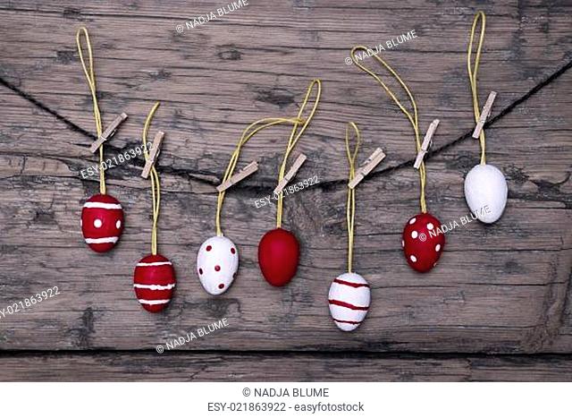 Many Red And White Easter Eggs Hanging On Line