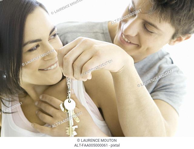 Man handing woman keys