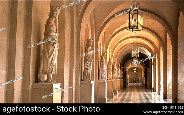 VERSAILLES, PARIS, FRANCE- SEPTEMBER 23, 2015: shot of a covered walkway with marble statues at the palace of versailles, paris france