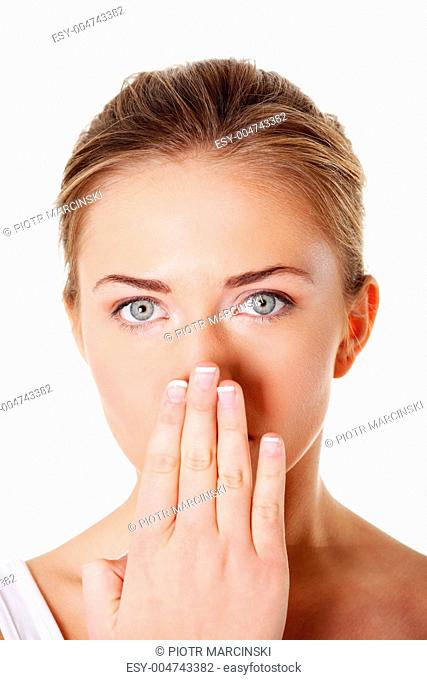 Teen woman covering her mouth with hands
