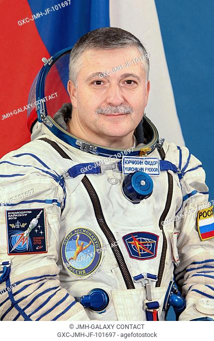Russian cosmonaut Fyodor Yurchikhin, Expedition 34 backup crew member, attired in a Russian Sokol launch and entry suit, takes a break from training in Star...
