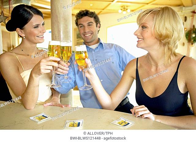 Man flirting with two women at a hotel bar
