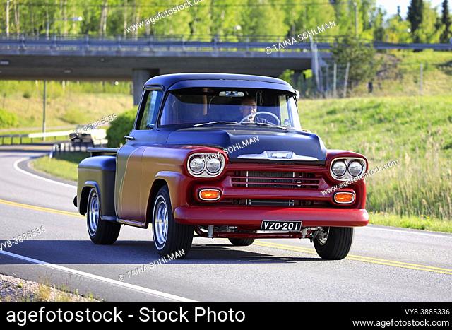 Beautiful red and black Chevrolet pickup truck, 1950s, on the road on Salon Maisema Cruising 2019. Salo, Finland. May 18, 2019