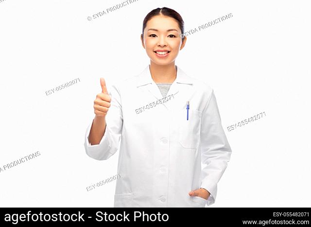 smiling asian female doctor showing thumbs up