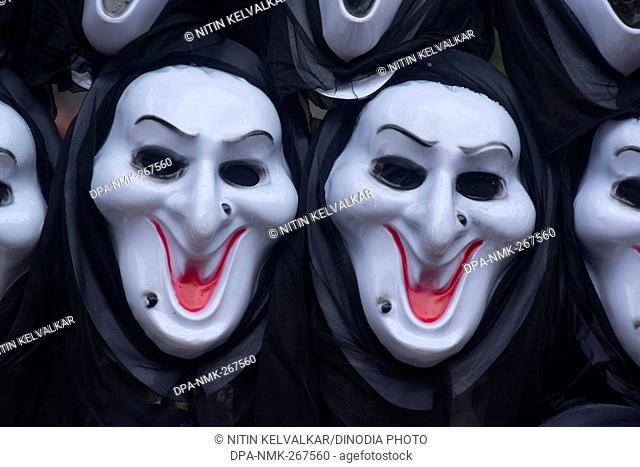 Plastic masks of Ghost and Skull kept for sell, Pune Maharashtra India Asia