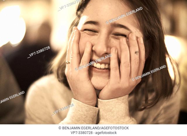 headshot of happy woman indoors in restaurant