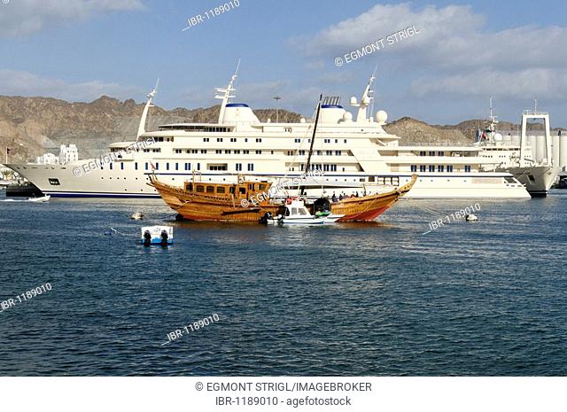 Old dhow and Sultan Qaboos royal yacht, Mutrah harbour, Muscat, Sultanate of Oman, Arabia, Middle East
