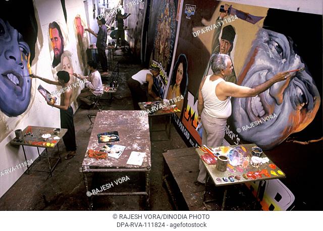 Artists at work , painting Bollywood film hoardings , Mumbai Bombay , Maharashtra , India