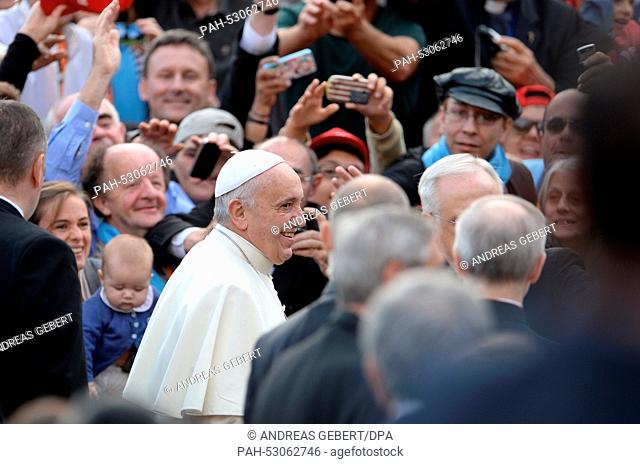 Pope Francis greets the crowd on his arrival for his Wednesday General Audience in Saint Peter's Square of the Vatican City, 22 October 2014