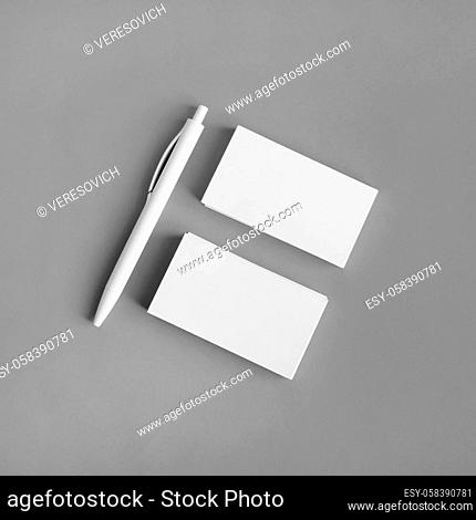 Template for ID. Blank business cards and pen on gray paper background. Flat lay
