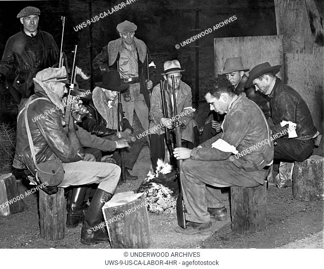 Verdi, Nevada: October 10, 1938.A group of posse men keep a campfire vigil in Nevada near the state line on Highway 50. They took up posts there when a group of...