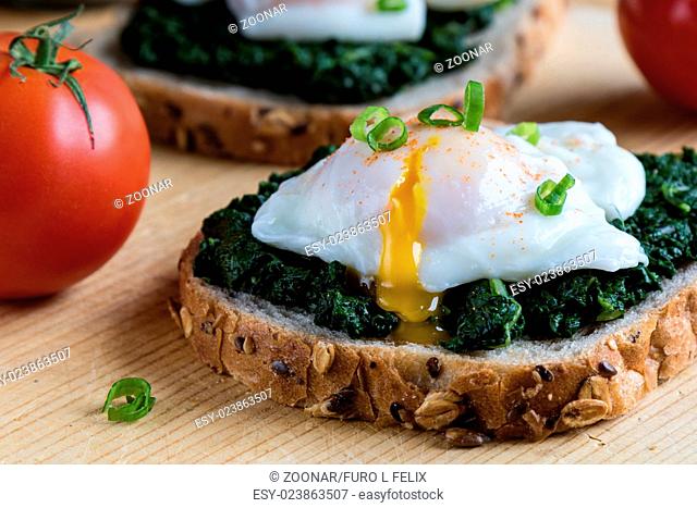 spinach and poached egg on brown bread