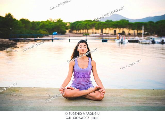Woman meditating at coast