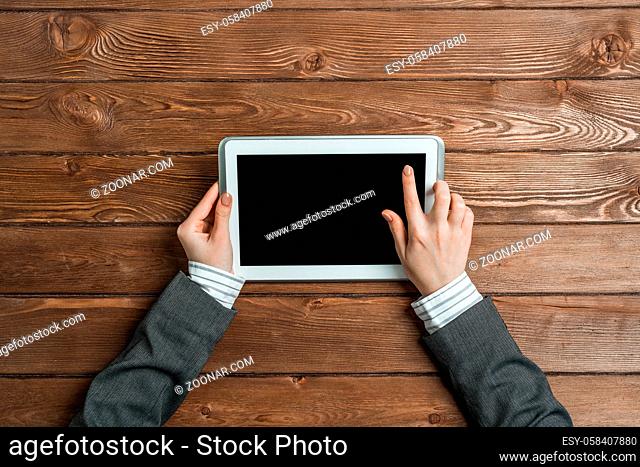 Close up of female hands touching screen with finger on tablet pc computer
