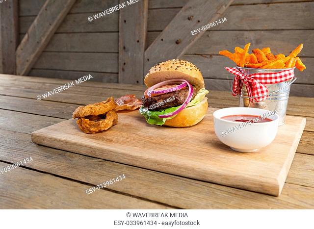 Hamburger, french fries, onion ring and tomato sauce