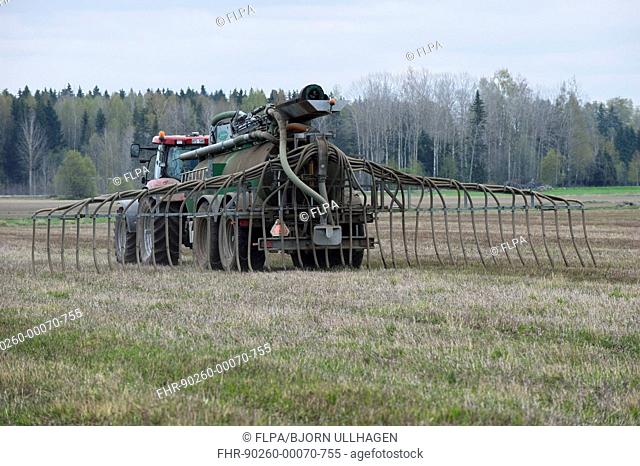 Case 225 tractor with Samson vacuum slurry tanker and slurry injector, injecting slurry into stubble field, Sweden, may