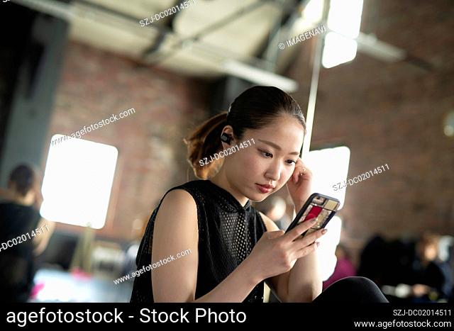 Woman listening music with smartphone