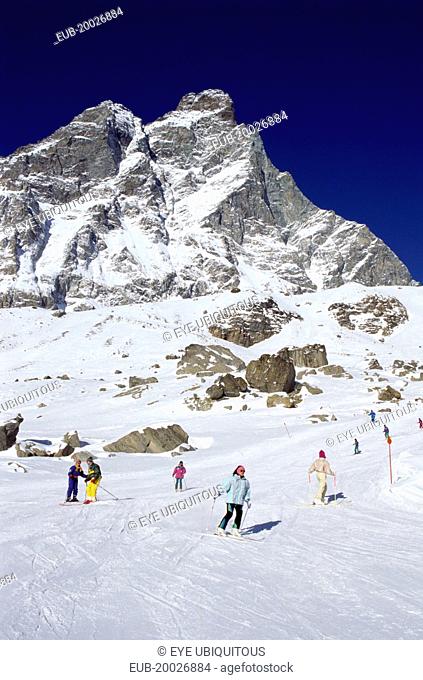 Skiers on the slopes of the Matterhorn ski range