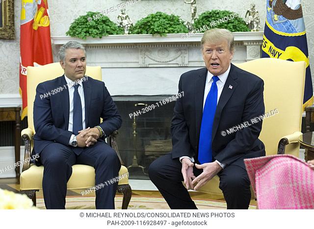 US President Donald J. Trump (R) delivers remarks beside President of Colombia Ivan Duque (L) during their meeting in the Oval Office of the White House in...