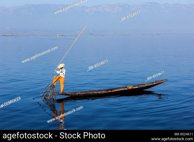 Myanmar travel attraction landmark, Traditional Burmese fisherman at Inle lake, Myanmar famous for their distinctive one legged rowing style