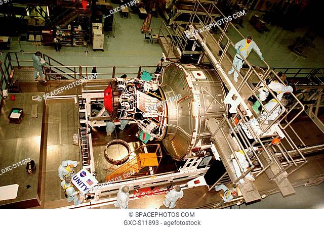 10/22/1998 --- In the Space Station Processing Facility, workers make a final check of the nameplate to be attached to the Unity connecting module