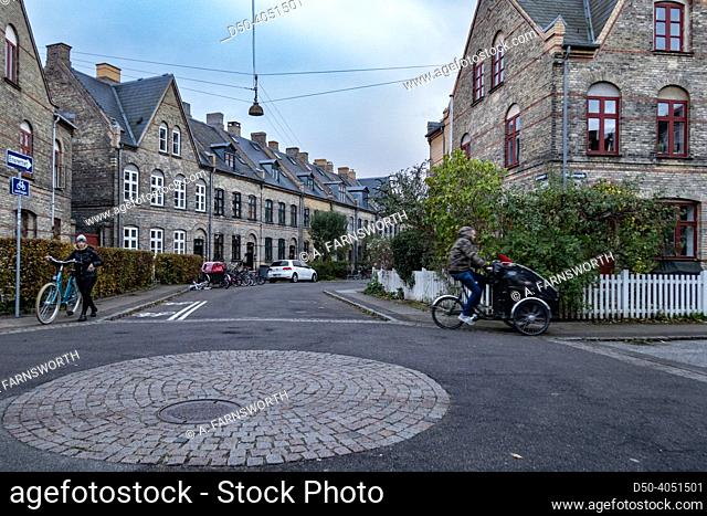 Copenhagen, Denmark Bicyclists at a roundabout in the old Humleby district with row houses