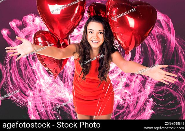 Sexy happy woman with balloons over fireworks background