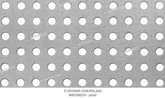 A pattern from a gray cardboard background with holes