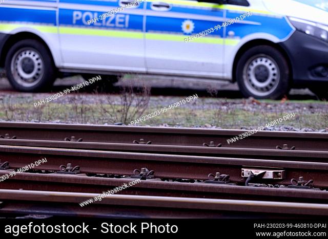03 February 2023, North Rhine-Westphalia, Recklinghausen: A Federal Police vehicle stands by the rail line after an accident involving two children hit by a...