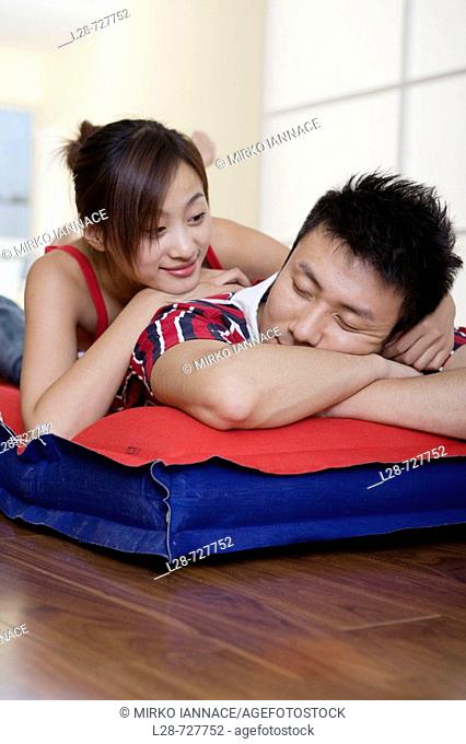 Young couple sleeping on bed, close-up