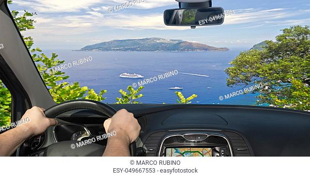 Driving a car towards the beautiful Sorrento Peninsula, seen from Capri, Bay of Naples, Italy