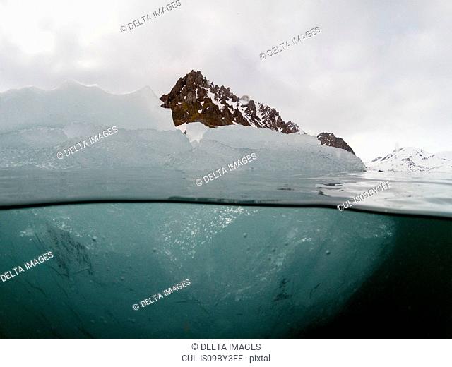Over and underwater view of iceberg, Burgerbukta, Spitsbergen, Svalbard, Norway