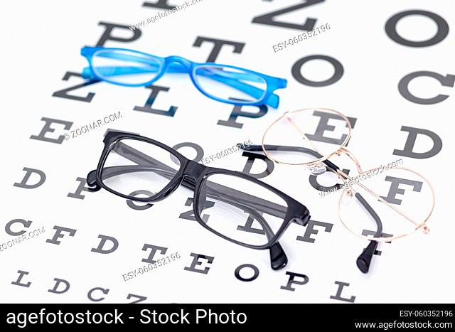 high angle of two pairs of glasses with letters