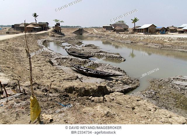 Two wooden boats in a parched riverbed, Cyclone Aila destroyed the dam and water flooded the former main street of Gabura in 2009, Sundabarns, Khulna District